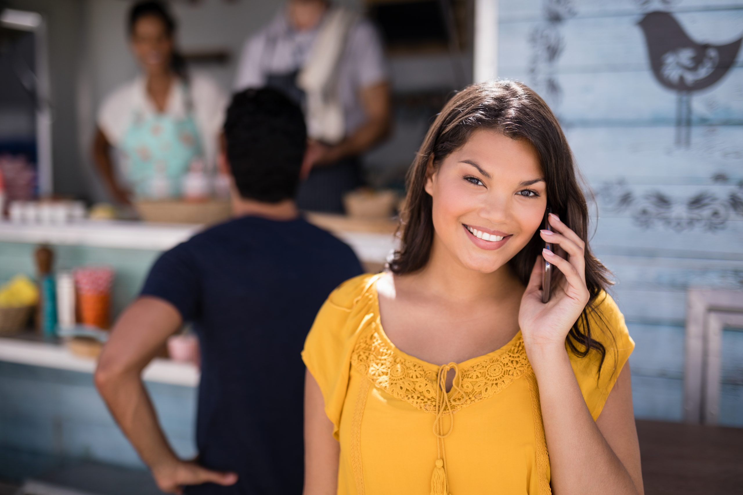 Portrait of smiling woman talking on mobile phone